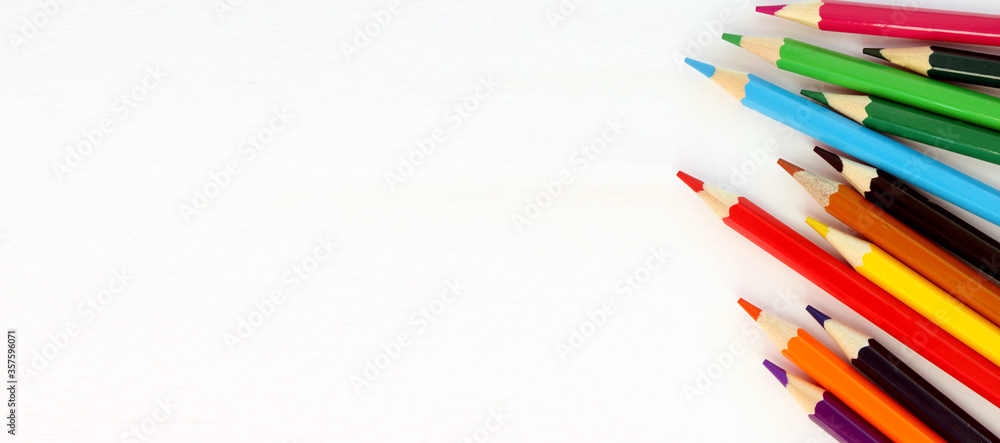 Colored pencils on white background. Lots of different colored pencils. Colored pencil. Pencils sharp. Pencils lie on right. Beautiful background. Close-up. Copy space. Background. Flatlay. Banner Colored pencils on white background. Lots of different colored pencils. Colored pencil. Pencils sharp. Pencils lie on right. Beautiful background. Close-up. Copy space. Background. Flatlay. Banner