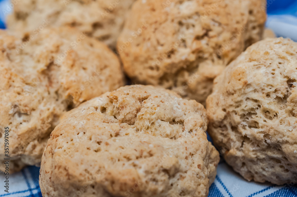 Delicious close up of scones from Eynsham Hall in a blue napkin. Exquisite english baker food. Grade II listed mansion near North Leigh in Oxfordshire, England, United Kingdom. Delicious close up of scones from Eynsham Hall in a blue napkin. Exquisite english baker food. Grade II listed mansion near North Leigh in Oxfordshire, England, United Kingdom.