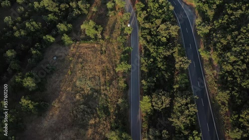 Aerial drone top view over natural reservoir in Algarve, Portugal. Sunset Landscape reveal Road and nature. Atlantic ocean in the background