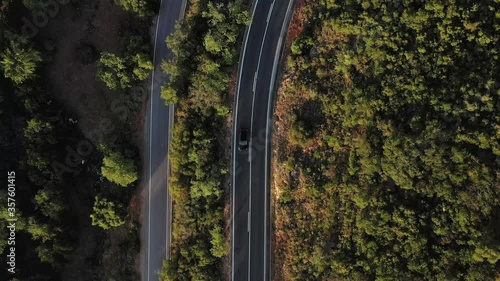 Aerial drone top view over natural reservoir in Algarve, Portugal. Sunset Landscape. Car passing by on a small road.