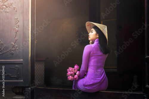 Beautiful vietnamese woman in Ao Dai white-traditional dress of vietnam, Ho Chi Minh city Vietnam