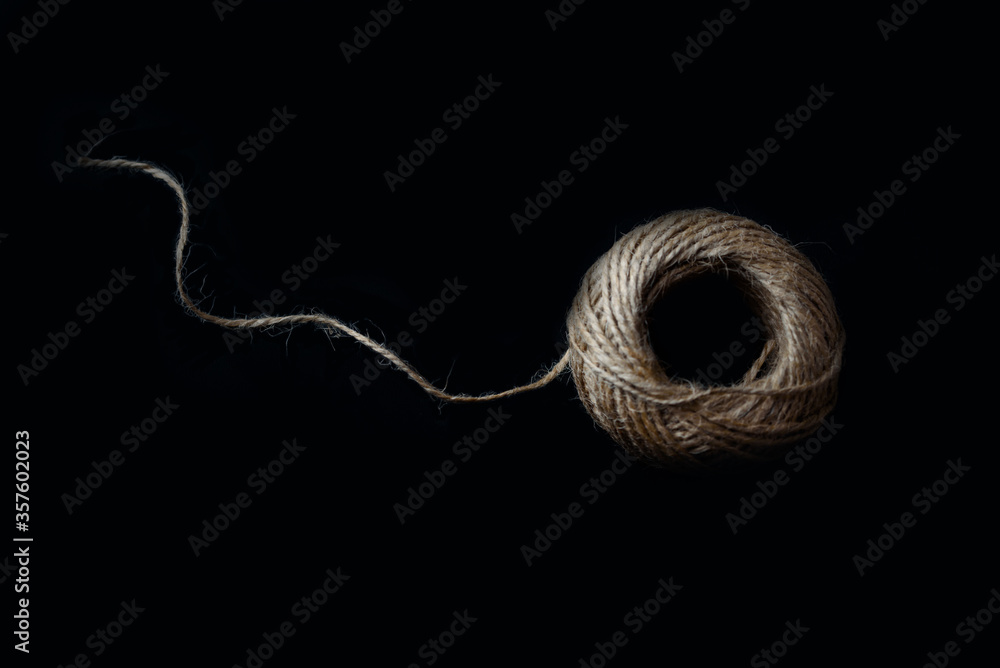a ball of twine on a black background a ball of twine on a black background