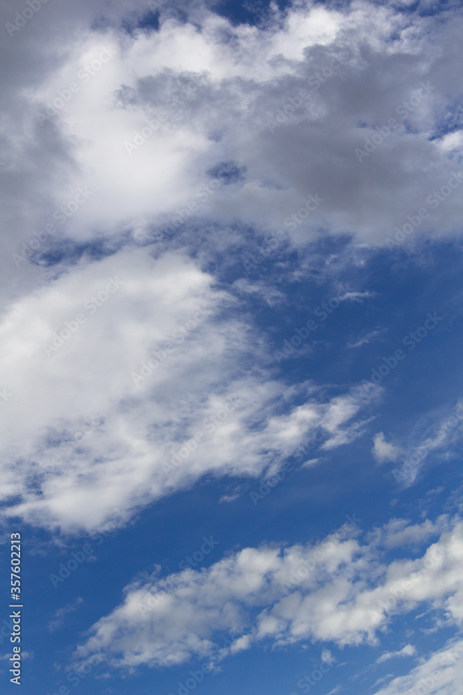 blue summer sky up with clouds vertical background 