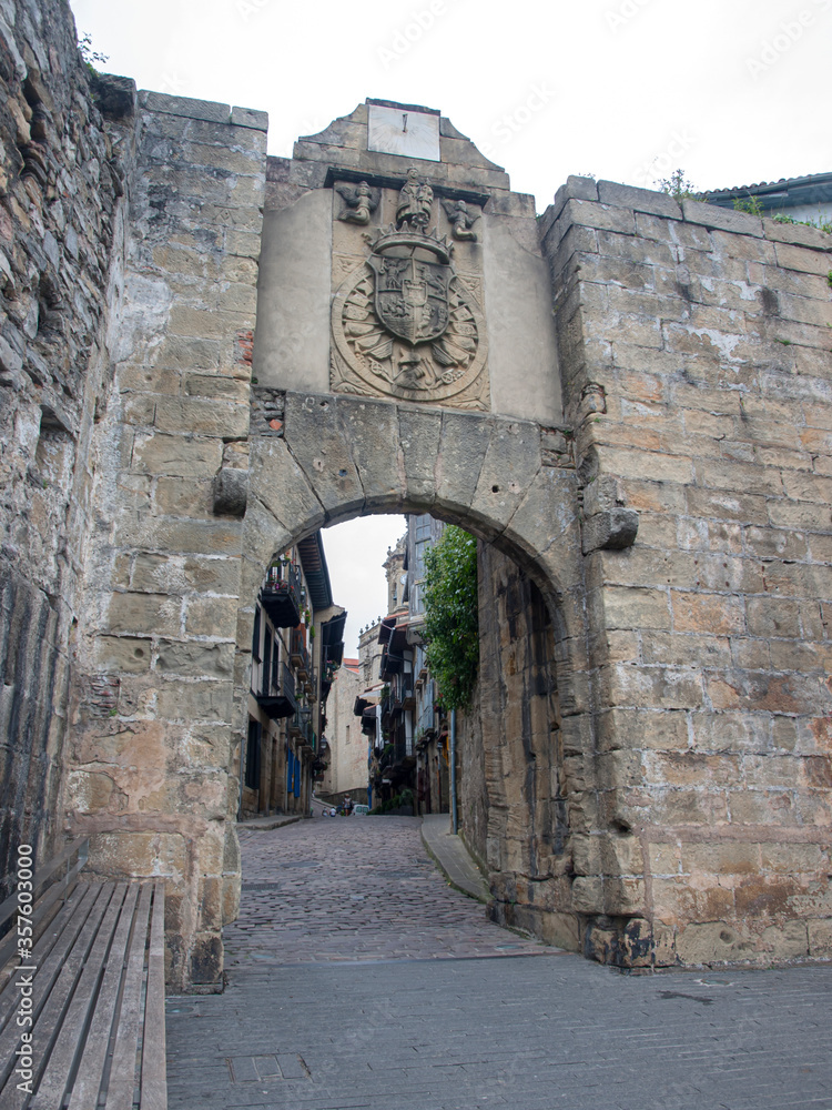 Santa Maria gate, one of the two entrance doors to the city, above it is the coat of arms of Hondarribia and a clock, Hondarribia, Guipúzcoa, Spain