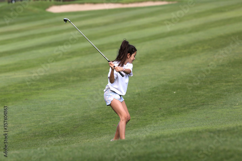 young girl playing golf