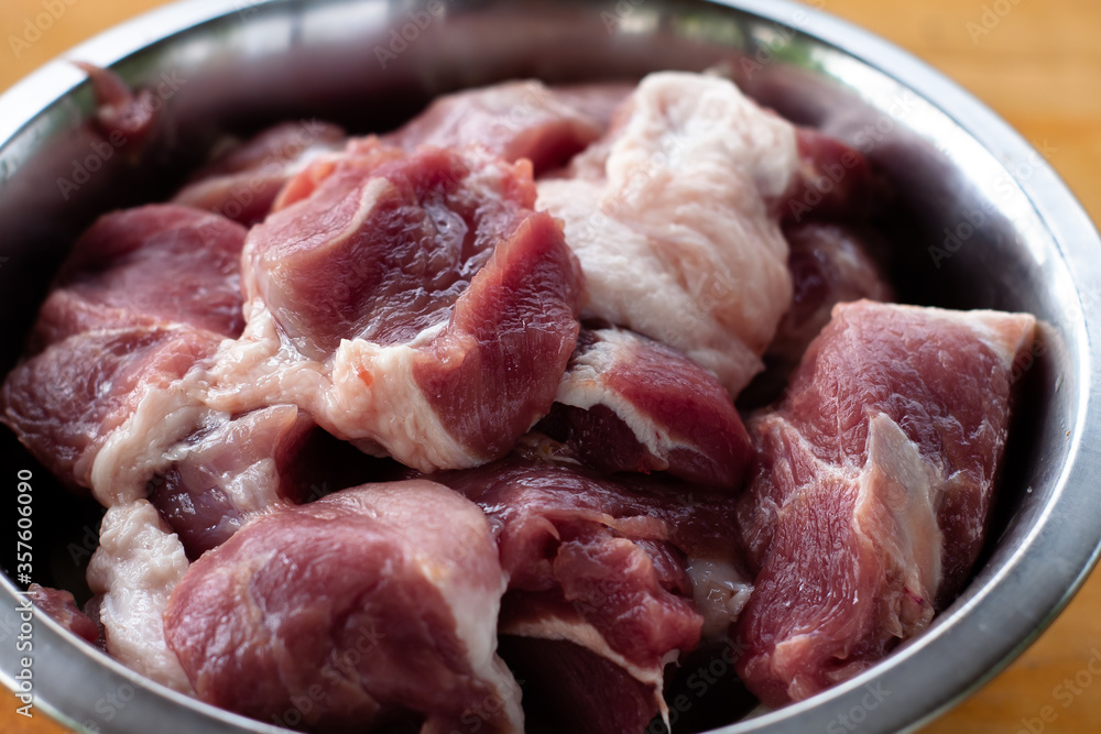 pork shoulder cut into pieces. raw meat in a bowl. for pickling. pork shoulder cut into pieces. raw meat in a bowl. for pickling.