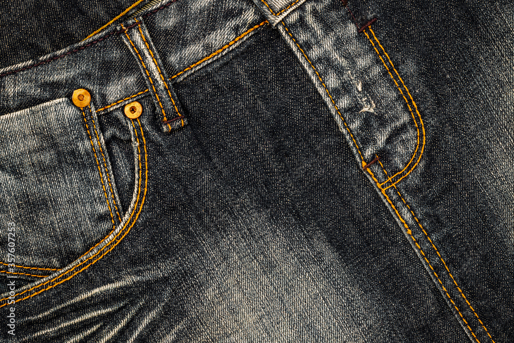 Denim jeans cloth in trendy used look design. Bleached scratched fabric backdrop - stock image