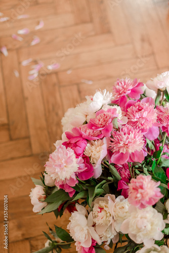 bouquets of peonies on wooden background © Юлия Батаева