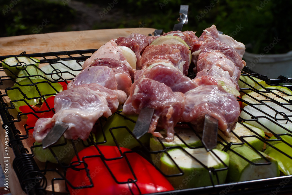 fresh pork meat on a skewer. preparation of a shish kebab.