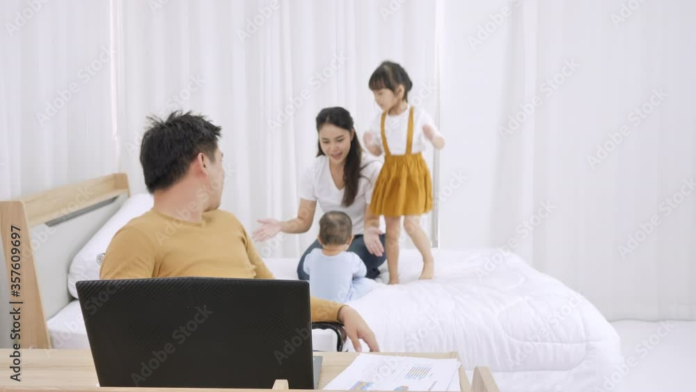 Man headache with asian family make noise and disturb working Man headache with asian family make noise and disturb working