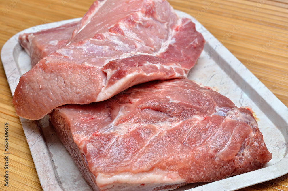 A piece of raw meat on a cutting kitchen table