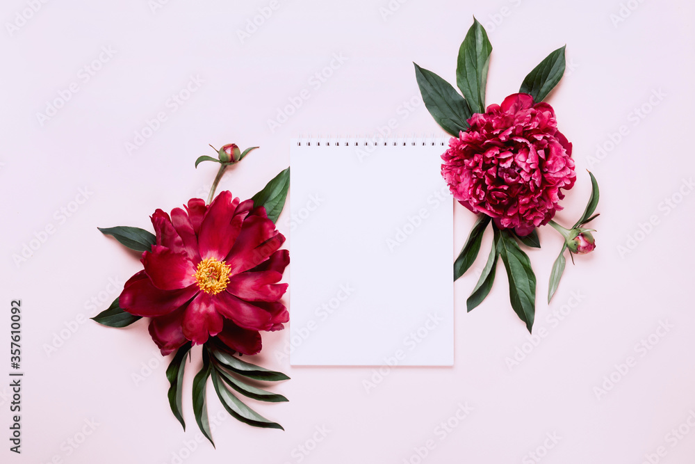 Beautiful peonies and notebook. White Floral background, copy space Beautiful peonies and notebook. White Floral background, copy space