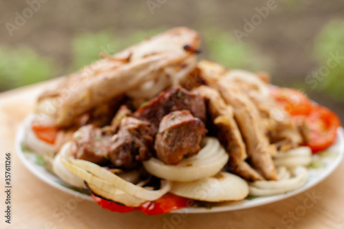grilled meat and vegetables on a plate. chicken, meat, pepper, onion, tomatoes