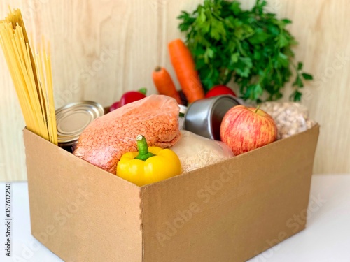 supplies food help box full of vegetables, canned, cereal, pasta and fruits. donation box for delivery charity. coronavirus volunteer donation isolated on white background