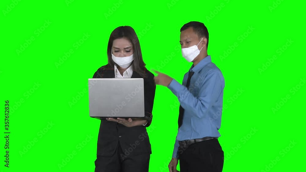 Business couple discussing with laptop on studio Business couple discussing with laptop on studio