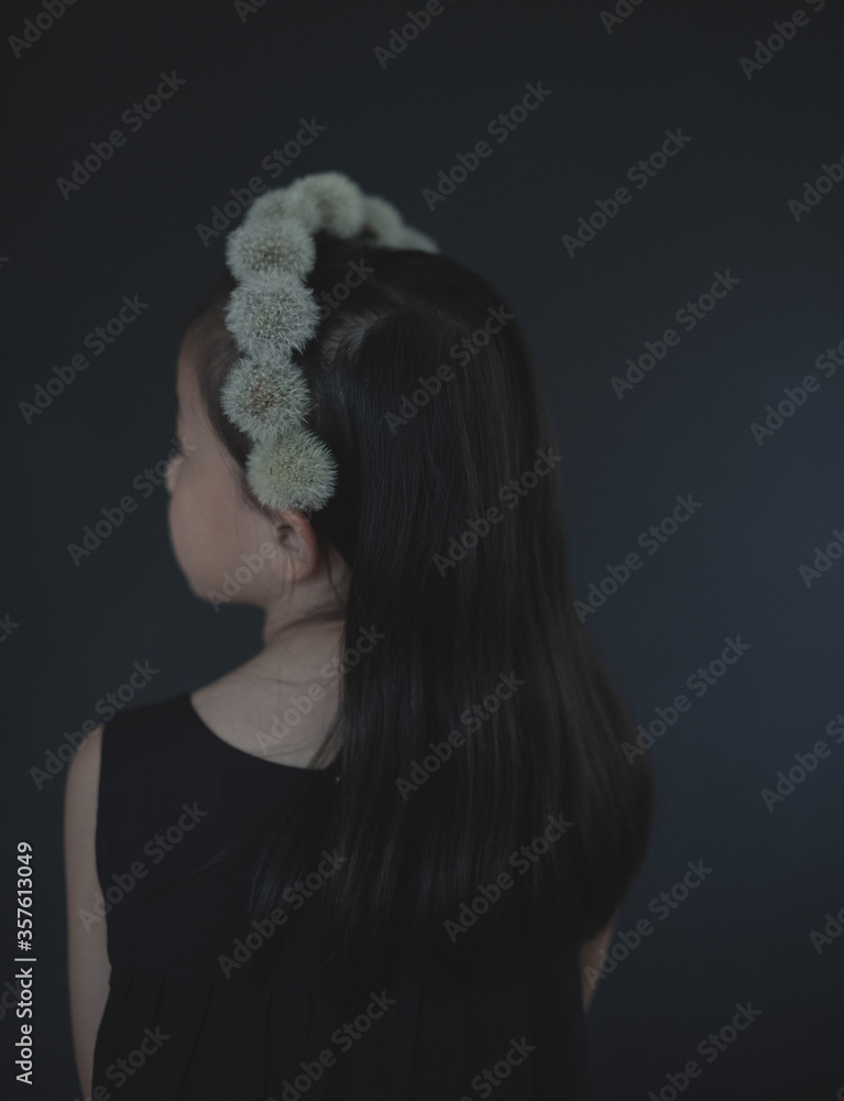 Rear view of girl wearing dandelion fluffs headband standing indoors Rear view of girl wearing dandelion fluffs headband standing indoors