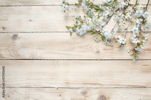 White flowers on a wooden background. Flowers are scattered on a wooden table. View from above