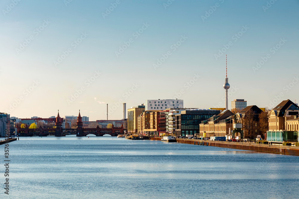 Berlin cityscape with oberbaumbridge and tv tower in foreground spree river