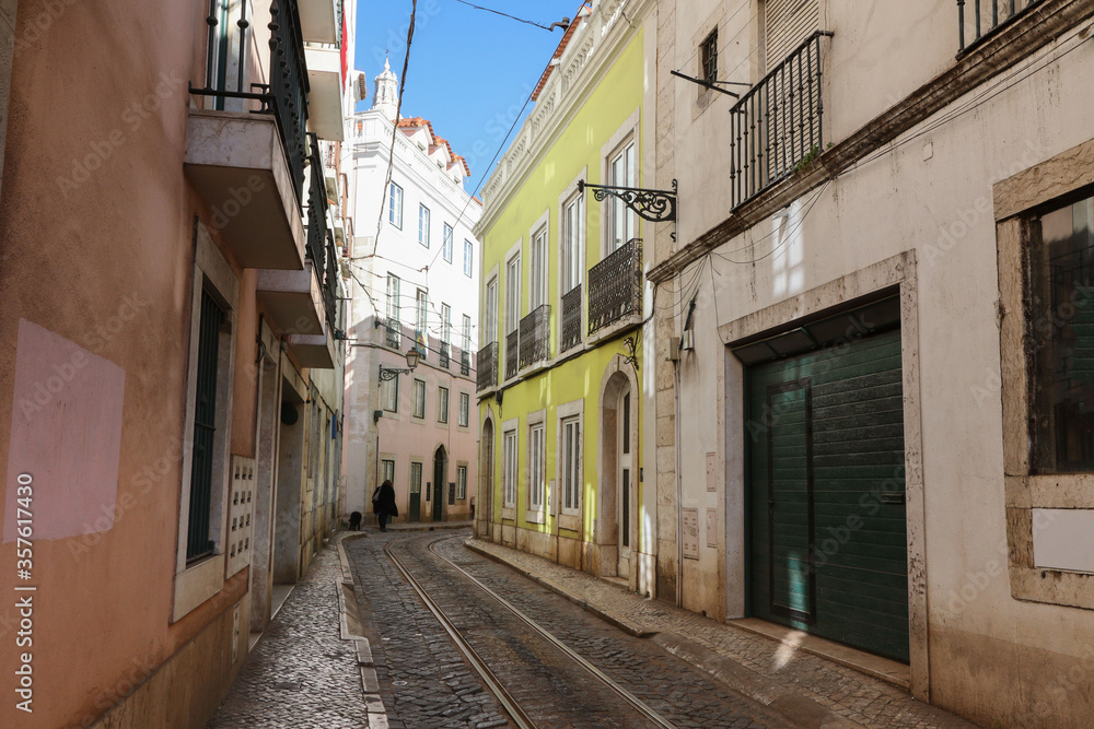 narrow street in the city centre with tram rails in Portugal