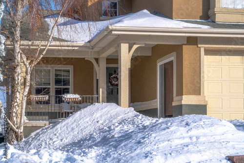 Home on mountainside residential community with porch and front door with wreath