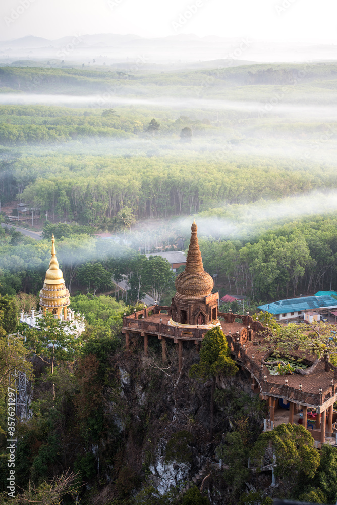 Naklejka premium High view of Khao Na Nai Luang temple with the colorful sky in the morning at Surat Thani Province, Southern of Thailand