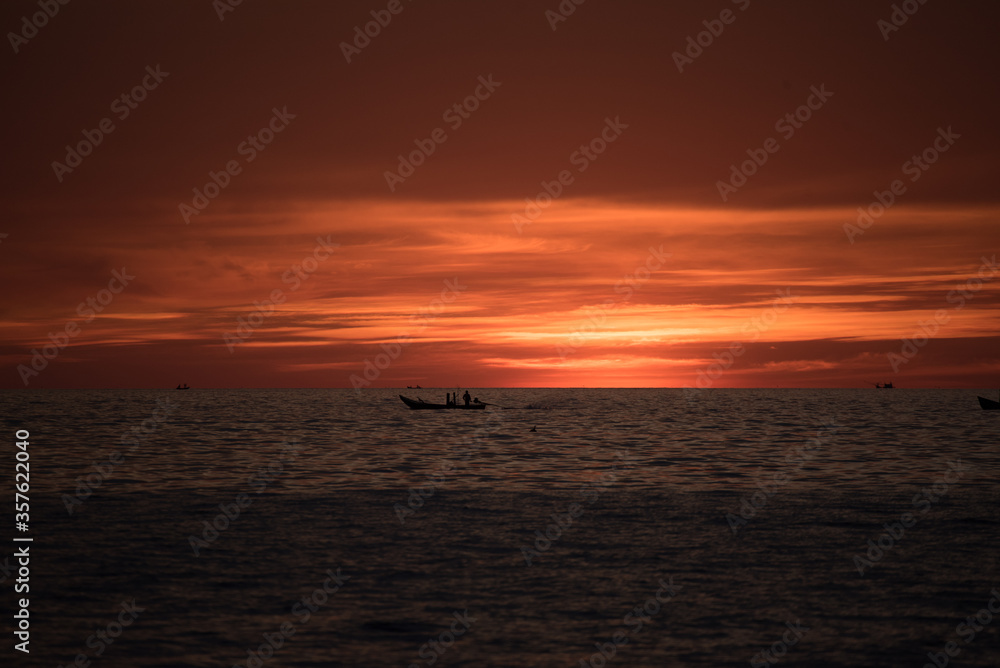 boat in sea with sunset 