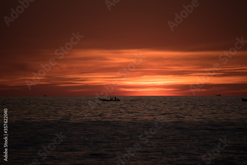 boat in sea with sunset 