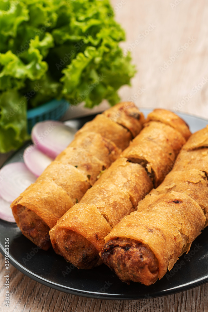 fried spring rolls and vegetables on wood fried spring rolls and vegetables on wood