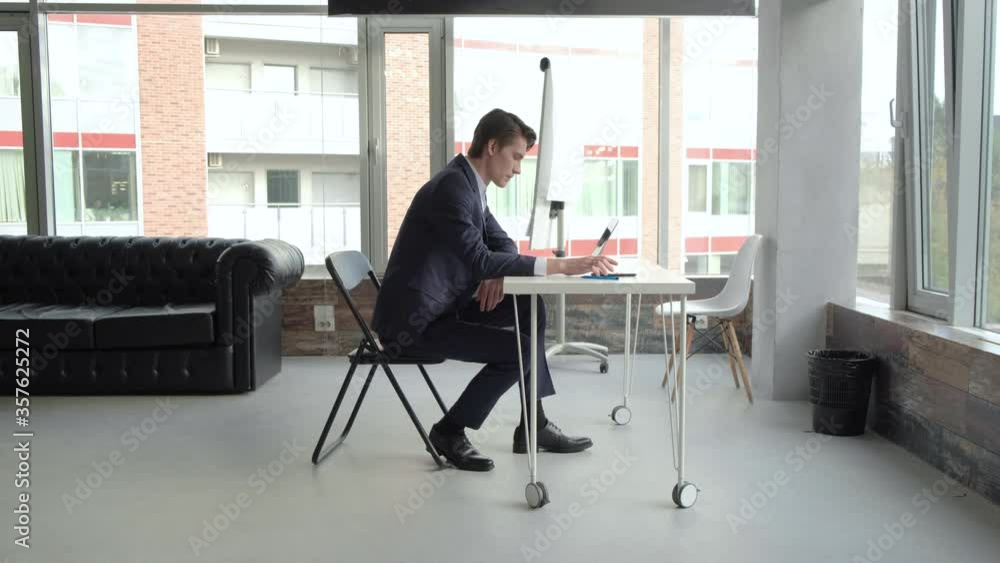 Focused business man entrepreneur typing on laptop doing research. Young male professional using computer sitting at home office desk. Busy worker freelancer working on modern tech notebook device. Focused business man entrepreneur typing on laptop doing research. Young male professional using computer sitting at home office desk. Busy worker freelancer working on modern tech notebook device.