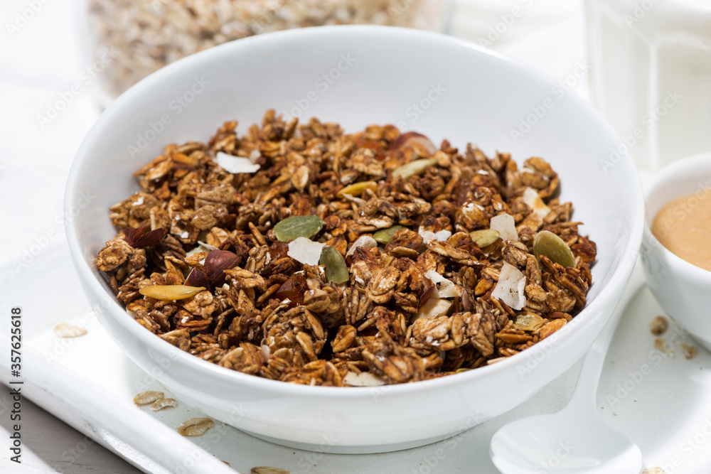 homemade chocolate granola, peanut butter and milk, closeup homemade chocolate granola, peanut butter and milk, closeup
