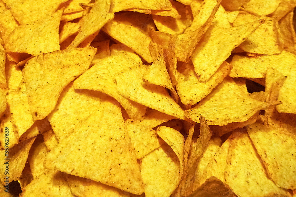 background texture of the crisp sliced spicy Potato chips. Delicious but unhealthy products. concept of Problems with obesity background texture of the crisp sliced spicy Potato chips. Delicious but unhealthy products. concept of Problems with obesity