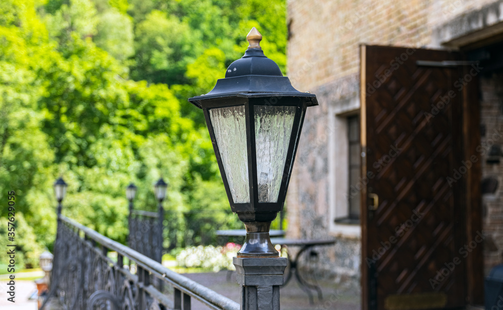Old cast-iron lantern in a city park. Close-up. Old cast-iron lantern in a city park. Close-up.