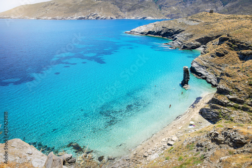 Elevated view to the popular Beach Tis Grias to Pidima with clean, turquoise sea at the island of Andros, Cyclades, Greece