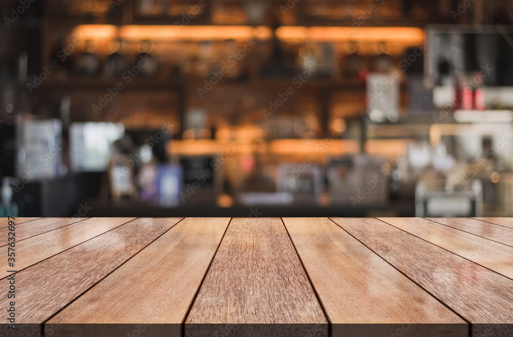 Empty wooden table top with lights bokeh on blur restaurant background Empty wooden table top with lights bokeh on blur restaurant background