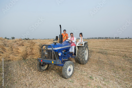 Rural family sitting on tractor