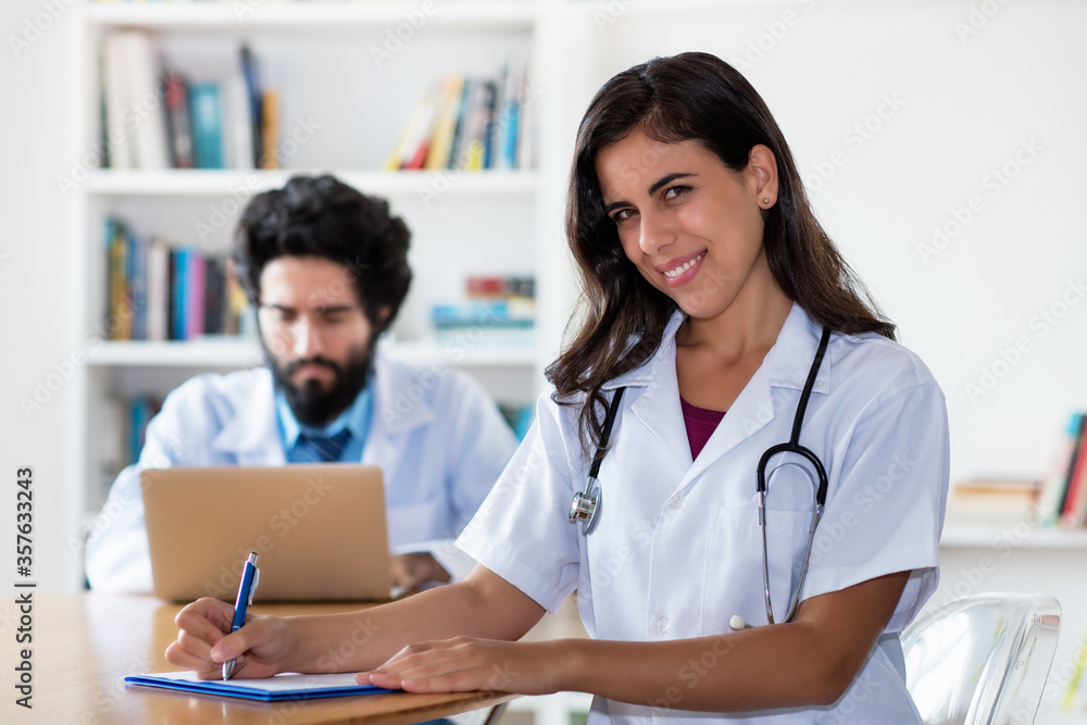 Laughing latin medical female student with doctor Laughing latin medical female student with doctor