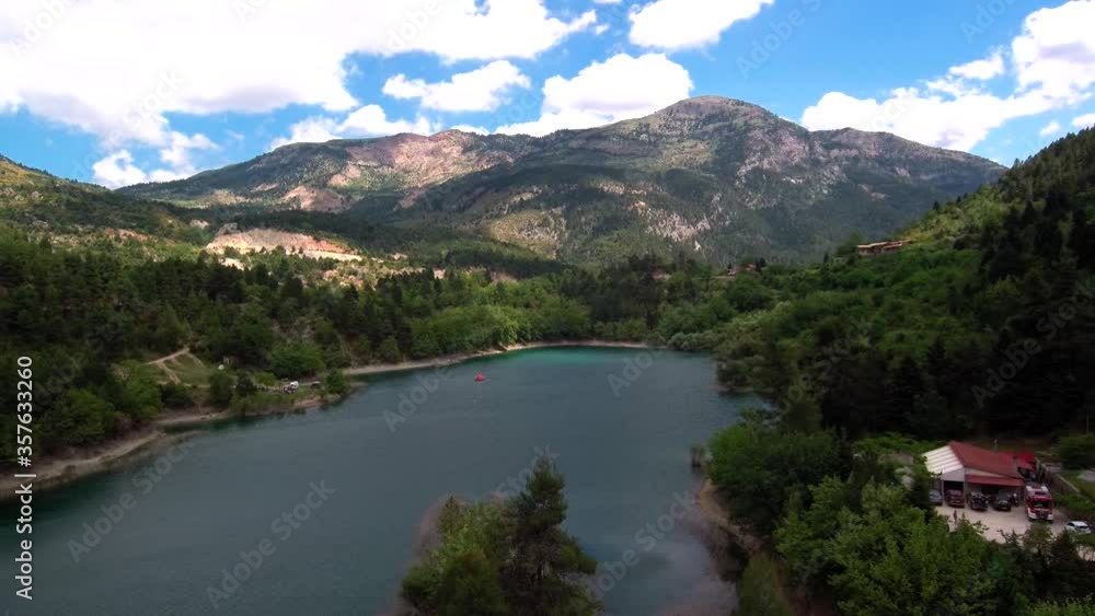 Aerial dolly in shot flying above lake Tsivlou in Peloponnese mountains of Greece with a bright overcast sky Aerial dolly in shot flying above lake Tsivlou in Peloponnese mountains of Greece with a bright overcast sky