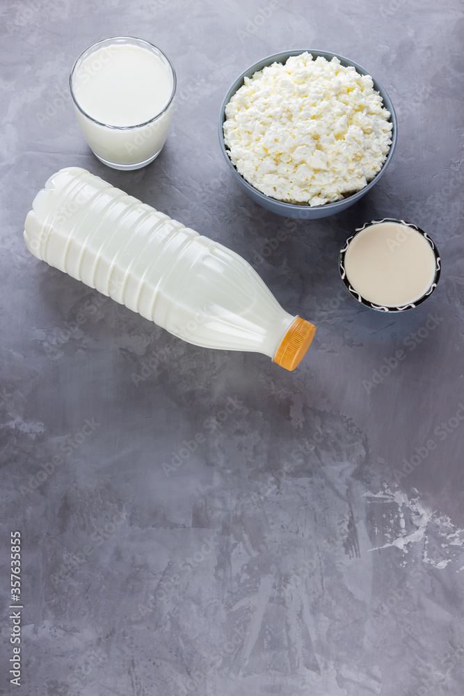 Various dairy products. Healthy dairy products on a gray background. Milk, sour cream and cottage cheese. Top view. Copy space Various dairy products. Healthy dairy products on a gray background. Milk, sour cream and cottage cheese. Top view. Copy space