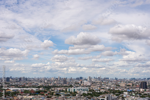 The Bangkok cityscape from skyscraper view with clouds and blue sky.