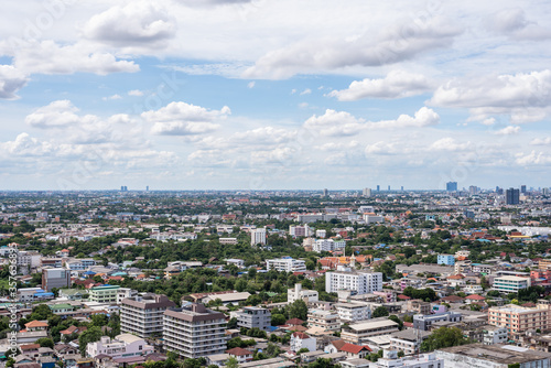 The Bangkok cityscape from skyscraper view with clouds and blue sky.