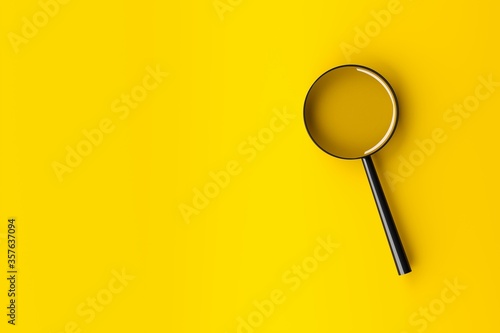 Magnifying glass with shadow on yellow background with copy space - minimal information search, find or exploration concept photo