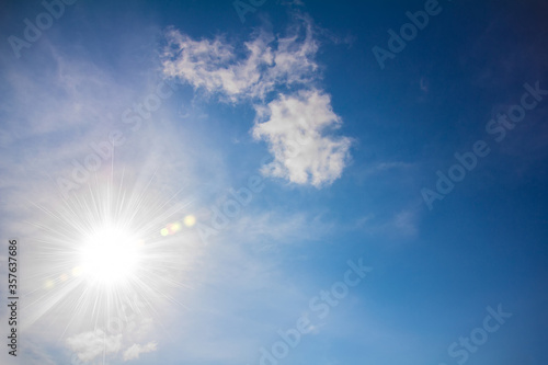 Blue Sky with Soft Clouds and Sun