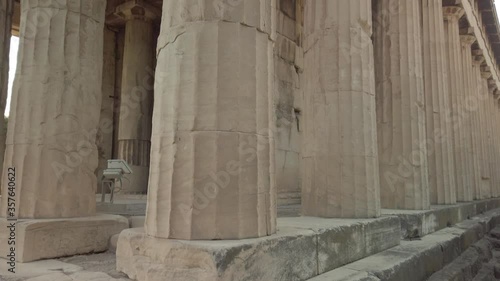 Tilt up and close up view of the Temple of Hephaestus in ancient agora of Athens, Monastiraki district, Greece. The most well-preserved ancient Greek temple. POV view from the base of the temple. photo