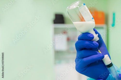 Doctor draws medicine into a syringe