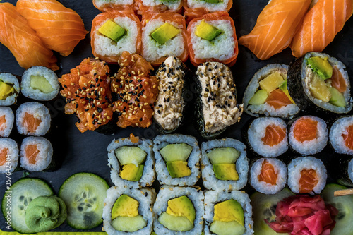 Sushi set restaurant. Black background. Japanese sushi food. Healthy food. Top view. Food set.