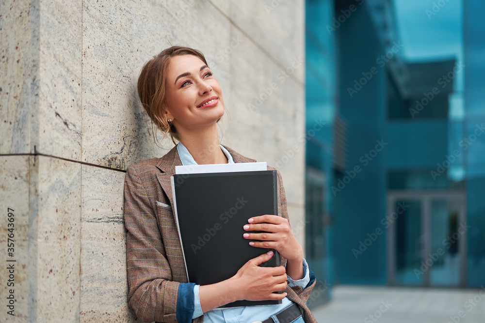 Businesswoman successful woman business person standing outdoor corporate building exterior. Pensiv caucasian confidence professional business woman middle age Businesswoman successful woman business person standing outdoor corporate building exterior. Pensiv caucasian confidence professional business woman middle age