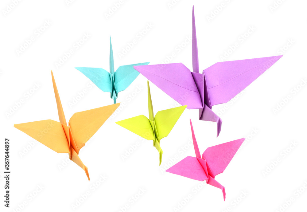 A group of origami cranes flying on white background A group of origami cranes flying on white background