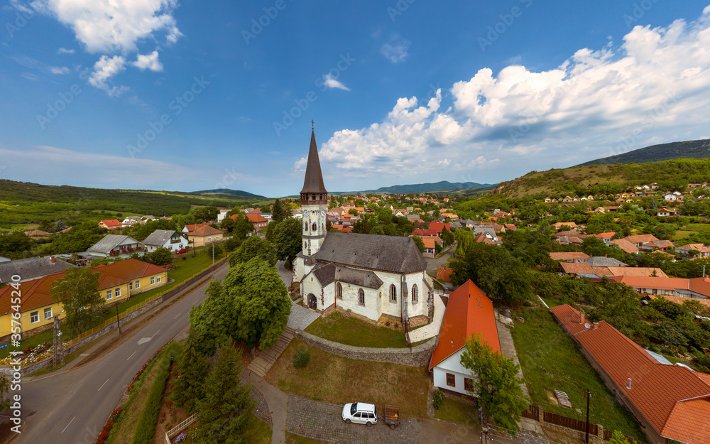 Aerial photo about the Church of the Assumption in Gyongyospata Hungary. Historical religious monument. Built in 12th century romanian baroque and gothic style. popular tourist attraction.