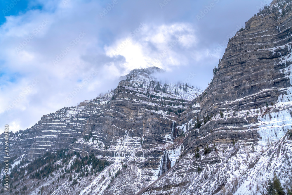 Cloudy blue sky over the scenic Provo Canyon with steep and rugged slopes Cloudy blue sky over the scenic Provo Canyon with steep and rugged slopes