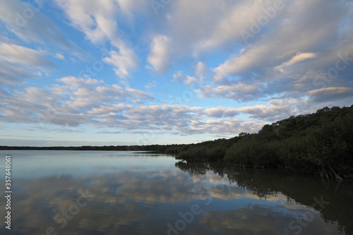 Sunrise over West Lake in Everglades National Park, Florida under striking cloudscape reflected in tranquil water.